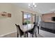 Dining room area with modern light fixture and sliding glass door to backyard patio at 3748 Pawnee Trl, Columbus, IN 47203