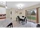 Bright dining room featuring sliding glass door, pendant lighting, and tile floors at 3748 Pawnee Trl, Columbus, IN 47203