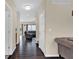 Hallway with hardwood floors leading to a living space, showing layout of the home at 3748 Pawnee Trl, Columbus, IN 47203