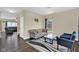 Cozy living room with neutral walls, dark wood floors, area rug, and natural light at 3748 Pawnee Trl, Columbus, IN 47203