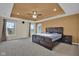 Spacious main bedroom with a tray ceiling, ceiling fan, and large windows with views at 3748 Pawnee Trl, Columbus, IN 47203