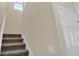 Carpeted stairs leading to the upper level with white trim at 3748 Pawnee Trl, Columbus, IN 47203
