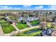 Stunning aerial view of the property showcasing lush landscaping, in-ground pool, and a picturesque pond at 3771 Lakewood Dr, Greenfield, IN 46140