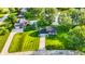 Aerial view of home on a spacious lot, with well-maintained lawn, mature trees, and close to a pond at 3771 Lakewood Dr, Greenfield, IN 46140