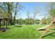Expansive backyard view featuring a picturesque lake and mature trees at 3771 Lakewood Dr, Greenfield, IN 46140