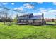 Spacious backyard featuring a multi-level deck and lush green lawn, perfect for outdoor entertaining and relaxation at 3771 Lakewood Dr, Greenfield, IN 46140