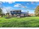 Expansive backyard featuring a wooden deck, fenced-in area, and lush green lawn for outdoor enjoyment at 3771 Lakewood Dr, Greenfield, IN 46140