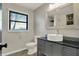 Bathroom features a vessel sink, black countertop, tile backsplash, and patterned tile flooring at 3771 Lakewood Dr, Greenfield, IN 46140