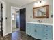 Bathroom features a vintage-look vanity with an undermount sink, mirror, and tile flooring at 3771 Lakewood Dr, Greenfield, IN 46140