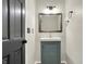 Bathroom features a wood-framed mirror, blue vanity, and tile flooring at 3771 Lakewood Dr, Greenfield, IN 46140