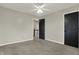 Bedroom features neutral carpet, light-colored walls, a ceiling fan, and a door to the hallway at 3771 Lakewood Dr, Greenfield, IN 46140