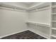 Spacious walk-in closet with ample shelving and dark wood-look flooring at 3771 Lakewood Dr, Greenfield, IN 46140