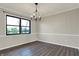 Dining room with modern chair rail, lovely floors, and chandelier lighting at 3771 Lakewood Dr, Greenfield, IN 46140