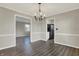 Charming dining room with updated flooring and fixture next to updated kitchen at 3771 Lakewood Dr, Greenfield, IN 46140