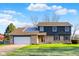 Charming two-story home with a brick facade, attached garage, and well-manicured lawn on a sunny day at 3771 Lakewood Dr, Greenfield, IN 46140