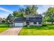 Charming two-story home with a brick and vinyl exterior, a well-manicured lawn, and mature trees at 3771 Lakewood Dr, Greenfield, IN 46140