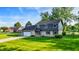 Charming two-story home with a brick and vinyl exterior, a well-manicured lawn, and a basketball hoop in the driveway at 3771 Lakewood Dr, Greenfield, IN 46140