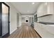 Open-concept kitchen seamlessly flows into the living room featuring an abundance of white cabinetry and counter space at 3771 Lakewood Dr, Greenfield, IN 46140