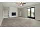 Inviting living room featuring a cozy fireplace, built-in shelving, and sliding glass doors to the deck at 3771 Lakewood Dr, Greenfield, IN 46140