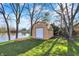 The backyard has a shed overlooking a serene pond, framed by mature trees on an impeccably manicured lawn at 3771 Lakewood Dr, Greenfield, IN 46140
