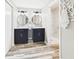 Bathroom featuring double vanity, gray walls, vinyl floors, and a stand up shower with white marble at 3913 Eastern Dr, Anderson, IN 46012