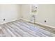 Neutral bedroom with light gray walls, gray vinyl plank flooring, and bright, natural light at 3913 Eastern Dr, Anderson, IN 46012