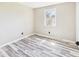 Bright bedroom with gray walls, light vinyl plank flooring, and natural light from a window at 3913 Eastern Dr, Anderson, IN 46012