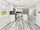 Well-lit kitchen featuring modern appliances, a central island, and an open view into the adjacent living space at 3913 Eastern Dr, Anderson, IN 46012