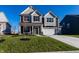 Beautiful two-story home with a combination of siding, stone accents, and a well-manicured lawn at 4068 Bozeman Way, Bargersville, IN 46106