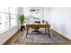 Bright home office featuring a wooden desk, stylish rug, and ample natural light from the large window at 4068 Bozeman Way, Bargersville, IN 46106