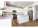 Bright kitchen features stainless appliances, marble countertops and white cabinets at 4068 Bozeman Way, Bargersville, IN 46106