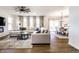 Open-concept living room with a large sectional sofa, modern fan, and view into the dining area at 4068 Bozeman Way, Bargersville, IN 46106