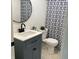 Stylish bathroom featuring modern fixtures, vanity, round mirror, and a patterned shower curtain at 414 Glendale Dr, Columbus, IN 47201