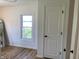 Bright bedroom featuring a view from the window, sleek wooden floors, and a closet door at 414 Glendale Dr, Columbus, IN 47201