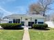 Charming home featuring a two-tone color scheme and well-manicured front yard, complemented by neat landscaping at 414 Glendale Dr, Columbus, IN 47201