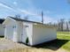 A well-maintained detached one-car garage featuring a durable roof and convenient side entry door at 414 Glendale Dr, Columbus, IN 47201