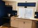 Bright kitchen features modern cabinets, stainless steel appliances, wood countertops and beautiful blue accent wall at 414 Glendale Dr, Columbus, IN 47201