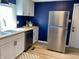 Bright kitchen features modern cabinets, stainless steel appliances, wood countertops and beautiful blue accent wall at 414 Glendale Dr, Columbus, IN 47201