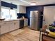 Bright kitchen features modern cabinets, stainless steel appliances, wood countertops and beautiful blue accent wall at 414 Glendale Dr, Columbus, IN 47201