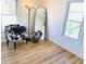 Cozy living room nook featuring a patterned chair, floor lamp, and decorative mirror at 414 Glendale Dr, Columbus, IN 47201