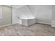 Finished attic space features wood look tile flooring and paneled walls and ceiling at 434 E New York St, Indianapolis, IN 46202