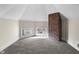 Finished attic space with diamond windows, brick column, and plush neutral carpeting at 434 E New York St, Indianapolis, IN 46202