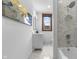 Bathroom features a modern vanity, subway tile in shower over tub, art and hexagon tile flooring at 434 E New York St, Indianapolis, IN 46202