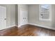 Bedroom with hardwood floors, fresh paint, closet and door to hallway, and a newer window at 434 E New York St, Indianapolis, IN 46202