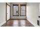 Bedroom with hardwood floors, two windows, fresh paint, and a white closet door at 434 E New York St, Indianapolis, IN 46202