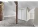 A cozy bedroom has grey carpeting, exposed brick, and a convenient closet at 434 E New York St, Indianapolis, IN 46202