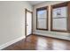 Bedroom with hardwood floors, two windows, fresh paint, and a white closet door at 434 E New York St, Indianapolis, IN 46202