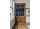 Charming built-in hutch featuring glass door fronts, decorative hardware, and hardwood floors at 434 E New York St, Indianapolis, IN 46202