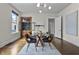Bright dining area with a glass table, stylish chairs, and a wooden cabinet at 434 E New York St, Indianapolis, IN 46202