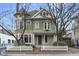 Charming two-story home featuring a delightful white picket fence and a well-maintained yard at 434 E New York St, Indianapolis, IN 46202
